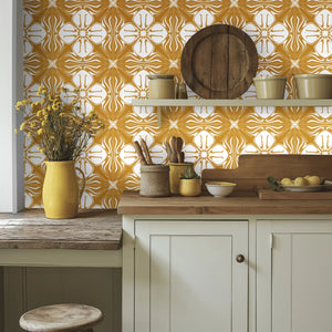 Santorini Tile wallpaper by Liberty James Studio in ochre and white, partly unrolled roll showing