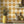 Santorini Tile wallpaper by Liberty James Studio in ochre, a Mediterranean tile pattern above a sideboard