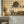 Santorini Tile wallpaper by Liberty James Studio in ochre, a Mediterranean tile pattern above kitchen cabinets