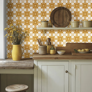 Santorini Tile wallpaper by Liberty James Studio in ochre, a Mediterranean tile pattern above kitchen cabinets