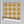 Santorini Tile wallpaper by Liberty James Studio in ochre, sample roll showing a Mediterranean tile pattern