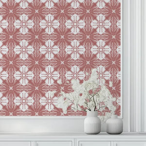 Santorini Tile wallpaper by Liberty James Studio in pink and white, a Mediterranean tile pattern behind a console table