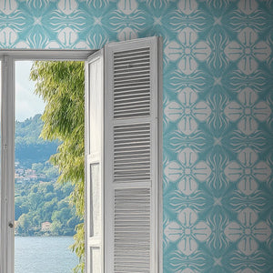 Santorini Tile wallpaper by Liberty James Studio in pale blue and white, partly unrolled roll showing