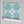 Santorini Tile wallpaper by Liberty James Studio in pale blue and white, a Mediterranean tile pattern in a dining area
