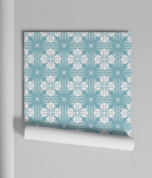 Santorini Tile wallpaper by Liberty James Studio in blue, partly unrolled roll showing a Mediterranean tile pattern