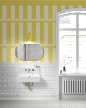 Scallop Lane wallpaper by Liberty James Studio in yellow and cream, roll showing scalloped stripes