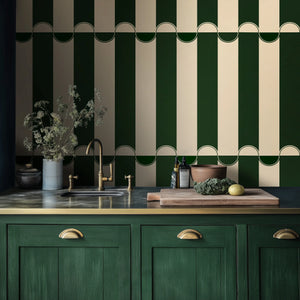 Scallop Lane wallpaper by Liberty James Studio in green, scalloped stripes behind bar stools