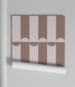 Scallop Lane wallpaper by Liberty James Studio in pink, partly unrolled roll showing scalloped stripes