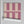 Scallop Lane wallpaper by Liberty James Studio in pink, roll showing scalloped stripes