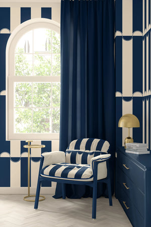 Scallop Lane wallpaper by Liberty James Studio in navy, scalloped stripes on a living room wall