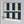 Scallop Lane wallpaper by Liberty James Studio in navy, partly unrolled roll showing scalloped stripes