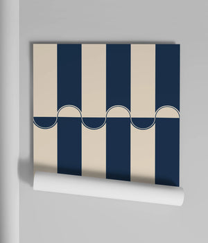 Scallop Lane wallpaper by Liberty James Studio in navy, partly unrolled roll showing scalloped stripes