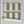 Scallop Lane wallpaper by Liberty James Studio in sage green, sample roll showing scalloped stripes