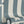 Scallop Lane wallpaper by Liberty James Studio in slate blue and cream, roll showing scalloped stripes
