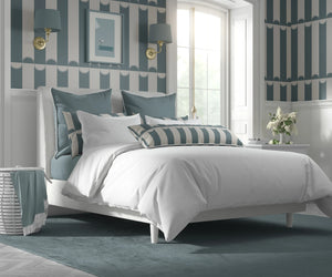 Scallop Lane wallpaper by Liberty James Studio in slate blue and cream, scalloped stripes in a bedroom