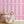 Scallop Lane wallpaper by Liberty James Studio in pink, scalloped stripes in a child's room
