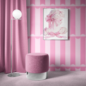 Scallop Lane wallpaper by Liberty James Studio in pink, scalloped stripes behind a sofa in a living room