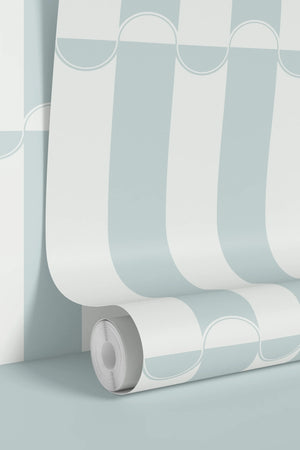 Scallop Lane wallpaper by Liberty James Studio in pale blue and white, scalloped stripes on a living room wall
