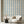 Scallop Lane wallpaper by Liberty James Studio in blue, scalloped stripes on a living room wall