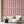 Scallop Lane wallpaper by Liberty James Studio in pink, scalloped stripes in a living room
