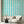 Scallop Lane wallpaper by Liberty James Studio in turquoise and white, scalloped stripes on a living room wall