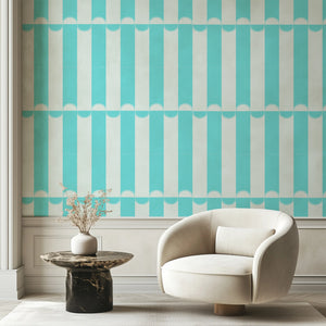 Scallop Lane wallpaper by Liberty James Studio in turquoise and white, scalloped stripes on a living room wall