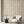 Scallop Lane wallpaper by Liberty James Studio in grey, scalloped stripes behind a sofa in a living room