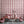 Scallop Lane wallpaper by Liberty James Studio in pink, scalloped stripes in a styled room setting