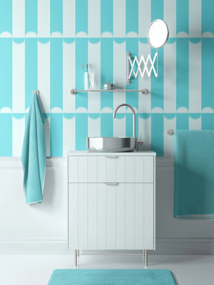 Scallop Lane wallpaper by Liberty James Studio in turquoise and white, scalloped stripes on a bathroom wall