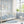 Scallop Lane wallpaper by Liberty James Studio in blue, scalloped stripes in a living room