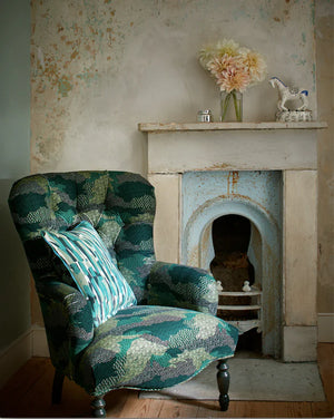 Ordnance Survey linen linen by Parker and Jules in green, a map-style camouflage print upholstered on an armchair