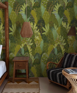 Savana wallpaper by Deus ex Gardenia in green, large savanna leaves in a bedroom
