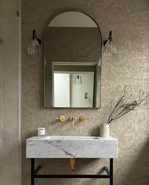 Fablewood wallpaper by Deus ex Gardenia in cream, a storybook woodland toile in a bathroom