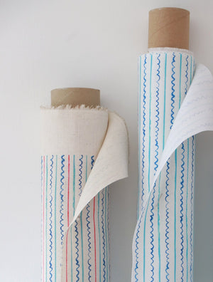 Sea Lines linen by Seed Home Designs in blue and white, roll showing fine watercolour stripes