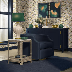 Shell Seekers wallpaper by Liberty James Studio in blue and yellow, a scallop shell pattern behind a sofa in a living room