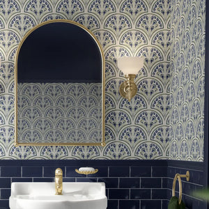 Shell Seekers wallpaper by Liberty James Studio in blue, a scallop shell pattern on a bathroom wall
