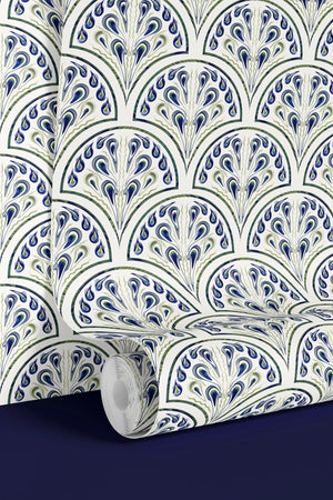 Shell Seekers wallpaper by Liberty James Studio in blue, partly unrolled roll showing a scallop shell pattern