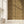 Shell Seekers wallpaper by Liberty James Studio in gold, a scallop shell pattern on a living room wall