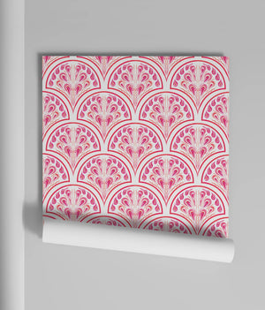 Shell Seekers wallpaper by Liberty James Studio in pink, partly unrolled roll showing a scallop shell pattern