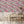 Silk Shades wallpaper by Brand McKenzie in pink, layered silk lampshades in a dining area