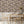 Silk Shades wallpaper by Brand McKenzie in grey, layered silk lampshades in a dining area