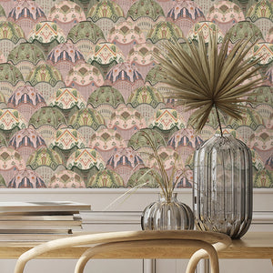 Silk Shades wallpaper by Brand McKenzie in coral and olive, layered silk lampshades behind a dining table