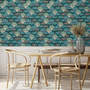 Silk Shades wallpaper by Brand McKenzie in teal, layered silk lampshades behind a dining table