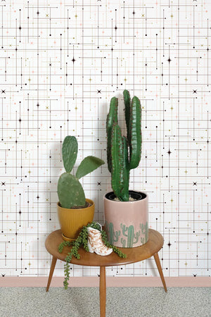 Star-Crossed wallpaper by Dupenny in cream, a star-crossed grid in a styled room setting