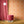 Hourglass wallpaper by Liberty James Studio in orange and pink, a retro hourglass wave in a living room