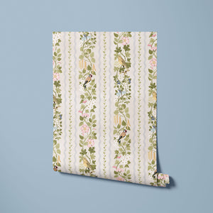 Hedgerows wallpaper by Studio Le Cocq in cream, partly unrolled roll showing hedgerow flowers and birds in stripes