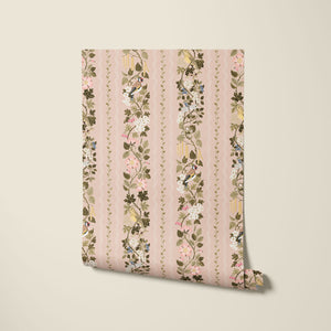 Hedgerows wallpaper by Studio Le Cocq in pink, partly unrolled roll showing hedgerow flowers and birds in stripes