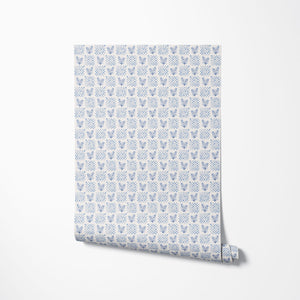 Picnic in the Flowers wallpaper by Studio Le Cocq in blue, partly unrolled roll showing a small floral lattice