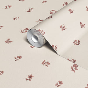 Cottage Ditsy wallpaper by Studio Le Cocq in burgundy, sample roll showing scattered ditsy flowers