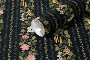 Hedgerows wallpaper by Studio Le Cocq in black, partly unrolled roll showing hedgerow flowers and birds in stripes